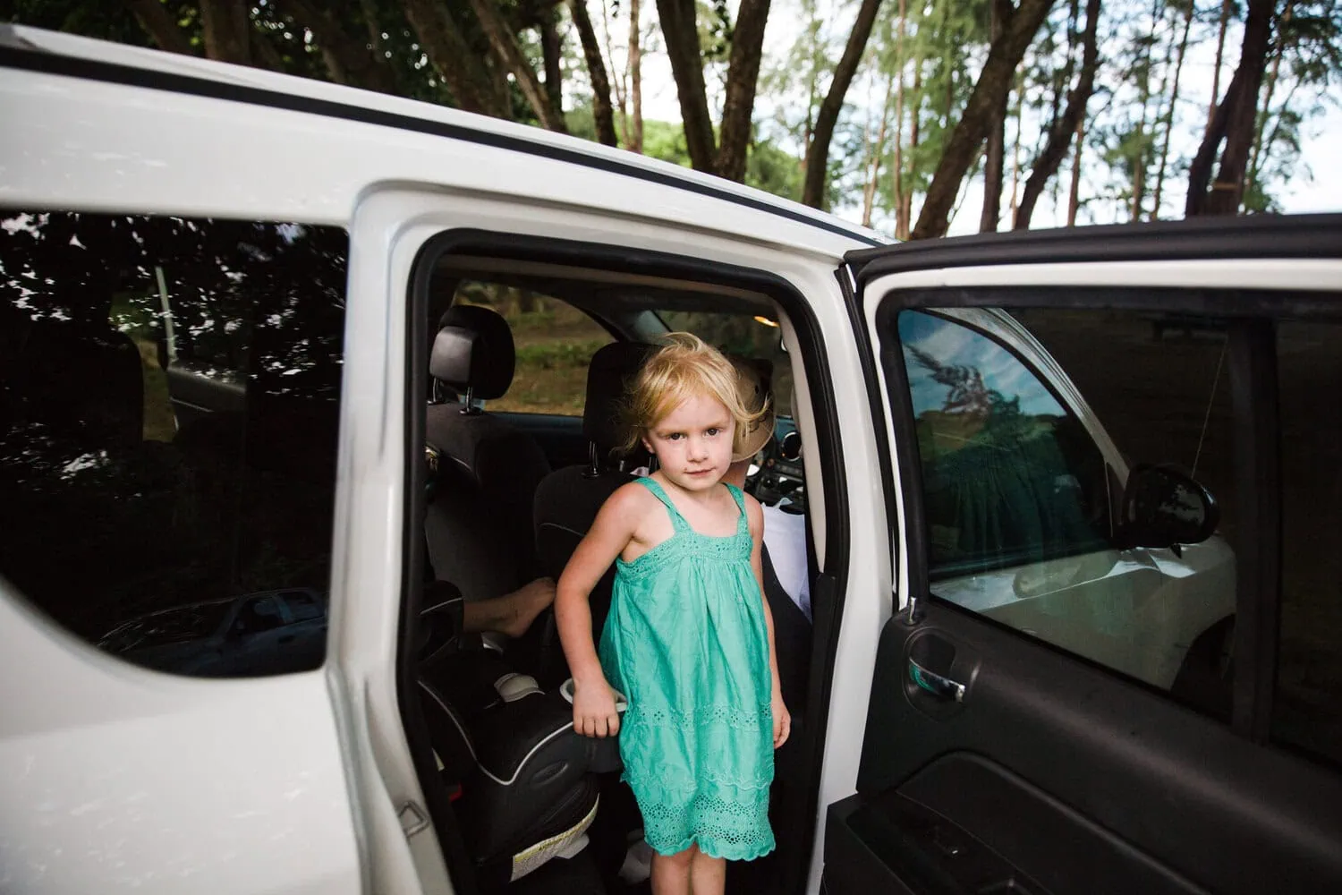 A child gets out of an open vehicle.