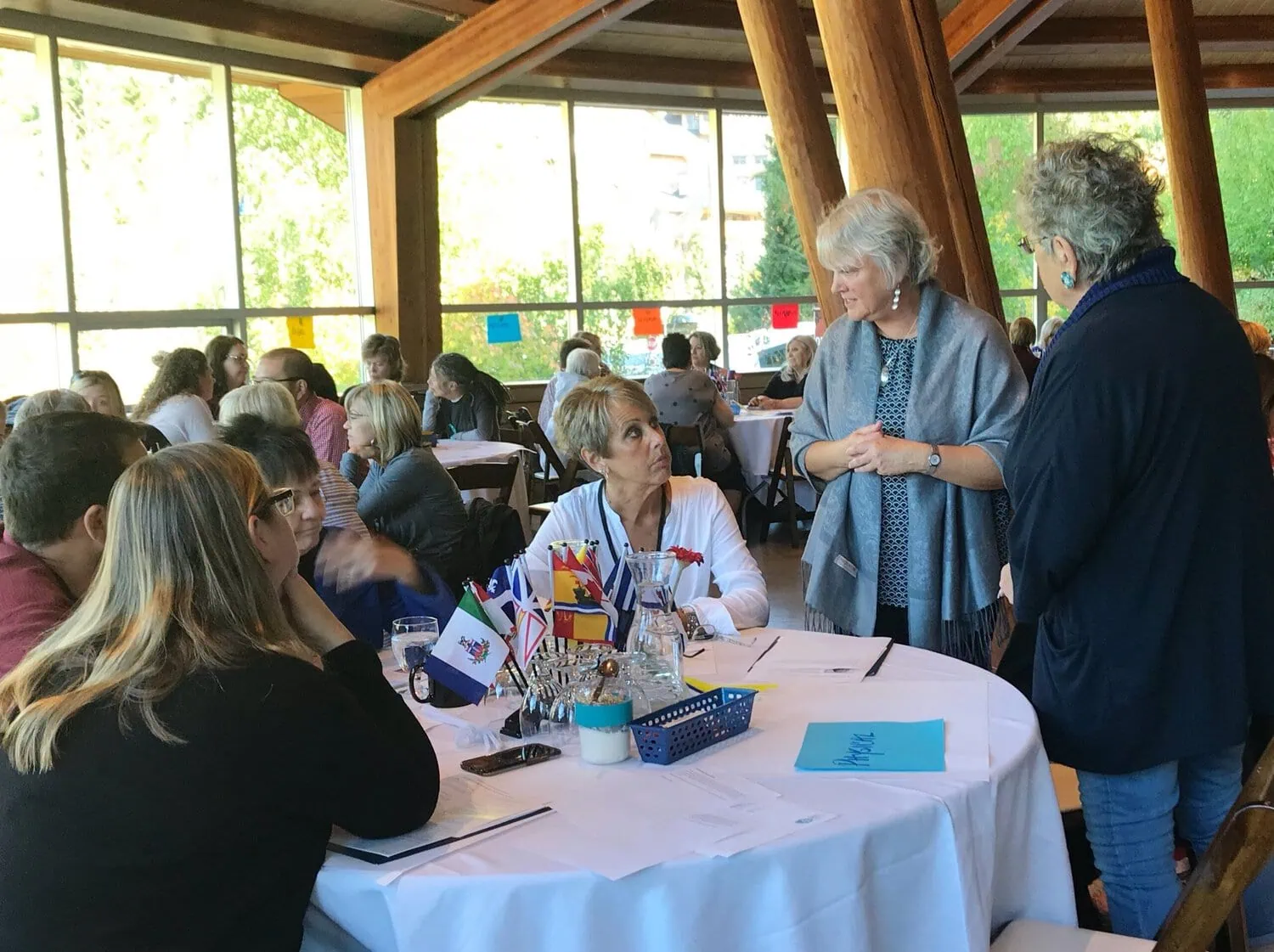 Attendees gather around tables during a BCFPA event.
