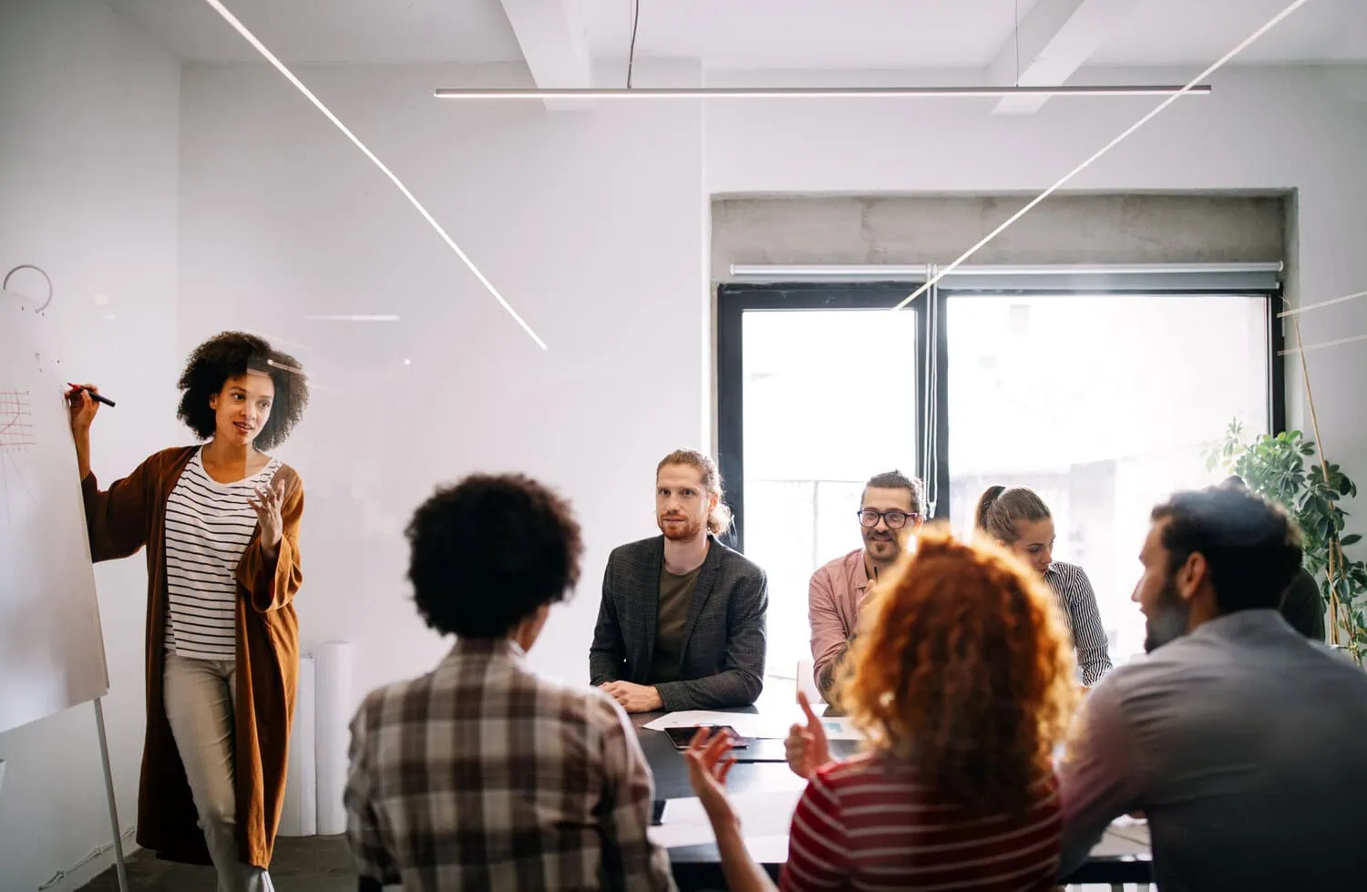 A presenter speaks to a group during a meeting.
