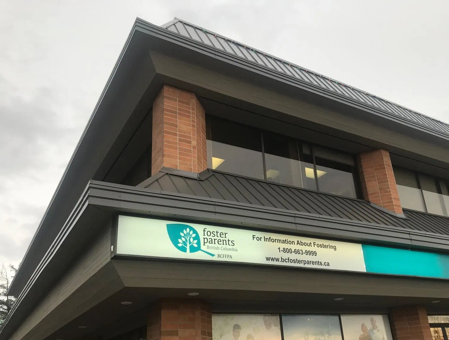 An office building with a foster parent organization sign above the entrance.