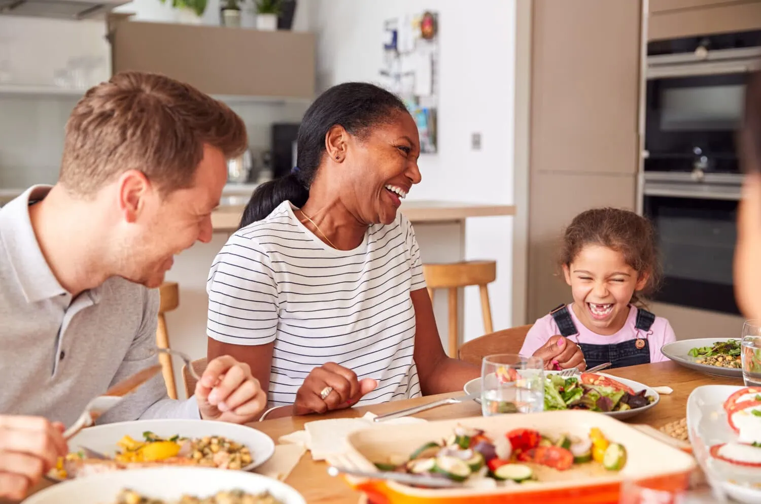 Several people share a meal around a table.